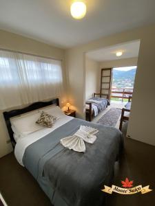 Postel nebo postele na pokoji v ubytování Monte Suíço Aconchego