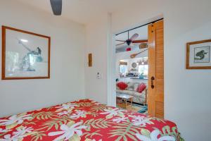 a bedroom with a bed and a living room at Inviting Aiea Bungalow with Balcony, Grill and Views! in Aiea