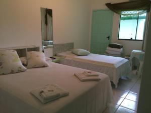 A bed or beds in a room at Hotel Pousada Reimar