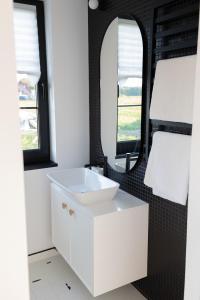 a bathroom with a white sink and a mirror at Przystanek na Podhalu in Długopole