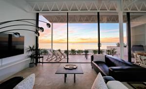 a living room with a couch and a view of the ocean at CasaCarbonito in Carboneras