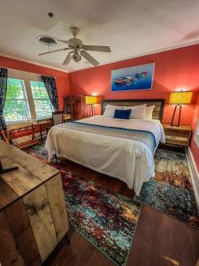 a bedroom with a large bed and red walls at Vinoy House in St Petersburg