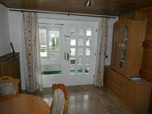 uma sala de jantar com uma porta branca e uma mesa em FeWo Ruhe em Olsberg