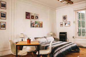 a bedroom with a bed and a table and chairs at Hostal Salvador in Santiago