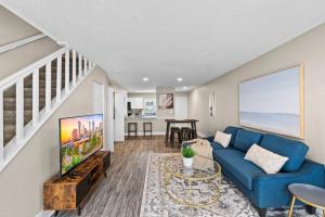 a living room with a blue couch and a table at Cozy Townhouse - Gym Pool Golf Fast WiFi 2B2B in Tampa