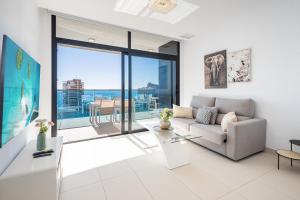 a living room with a couch and a table at Sunset Drive Resort Apartment 4-8 Poniente Beach in Benidorm