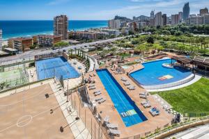 an aerial view of a pool with a city and the ocean at Sunset Drive Resort Apartment 4-8 Poniente Beach in Benidorm