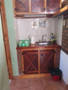 a small kitchen with a sink and a counter top at MAE in Esquel