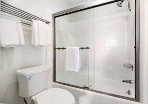 a white bathroom with a shower and a toilet at Brooks Beach Vacations House B222 Oceanside in Oceanside