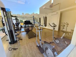 a gym with several exercise equipment in a room at Atlantic Garden Wanderlust House in Corralejo