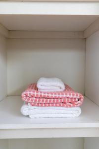 a pile of towels sitting on a shelf at Elwood Star- Beachside Retreat in Melbourne