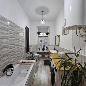 a large bathroom with a tub and a sink at Villa Münz Apartment Franz in Pula