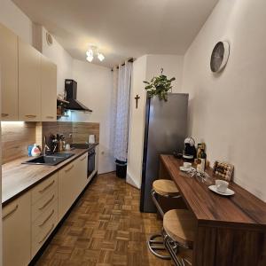 a kitchen with a table and a refrigerator at Villa Münz Apartment Franz in Pula