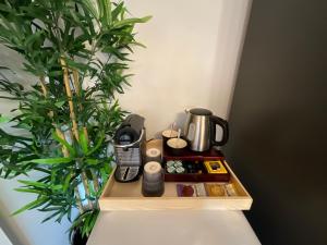 a wooden shelf with a coffee maker and a plant at Simply relax in London