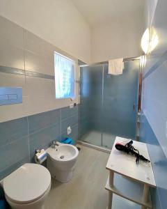 a bathroom with a toilet and a shower and a sink at Holiday House Ginevra in Formia +39 photos