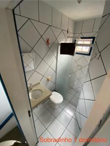 a small bathroom with a toilet and a sink at Parada dos Golfinhos in Florianópolis