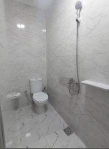 a white bathroom with a shower and a toilet at Hotel Group in Cairo
