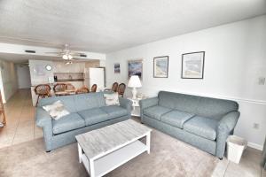 a living room with two blue couches and a table at 0512 Waters Edge Resort condo in Myrtle Beach