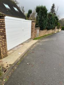 a white gate on the side of a house at Maison near Disneyland , Paris in Champs-Sur-Marne