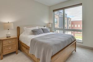 a bedroom with a bed and a large window at Silverthorne Townhome with Hot Tub Walk to Town! in Silverthorne
