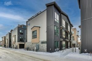 a row of buildings on a snowy street at Silverthorne Townhome with Hot Tub Walk to Town! in Silverthorne