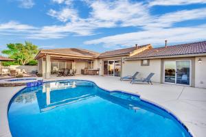 a swimming pool in front of a house at Oasis Retreat at Henderson Greens in Las Vegas