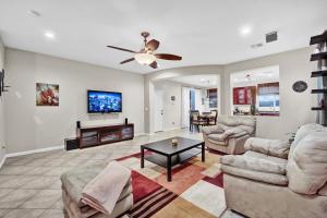 a living room with two couches and a flat screen tv at Todor Las Vegas Home Away From Home in Las Vegas