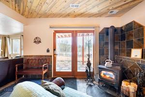 a living room with a fireplace and a stove at Meandering Moose Apartment in Black Hawk