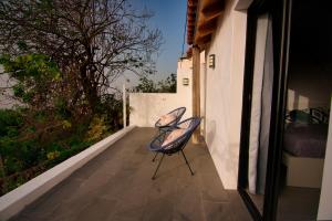 a chair sitting on a porch of a house at Casita Las Toscas in La Matanza de Acentejo