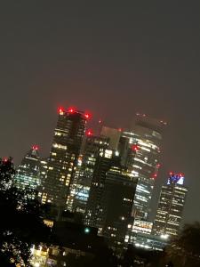 a lit up city skyline at night with red lights at FAST STAY NOW in London