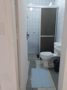 a bathroom with a toilet and a sink at Reencanto Sonho Azul in Palhoça