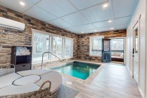 a swimming pool in a room with a brick wall at Little Sister's Cabin in Pigeon Forge