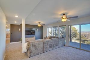 a living room with a couch and a ceiling fan at Cedar City Home with Mountain Views and Game Room! in Cedar City
