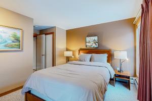 a bedroom with a large bed and two lamps at Trail Creek 53 in Killington +49 photos