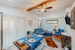 a living room with a blue couch and a tv at Two Canoe in Sonora