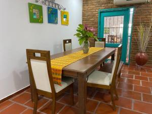 a dining room table with chairs and a yellow table cloth at Casa campestre San José - Descansa y Diviértete in Santo Tomás
