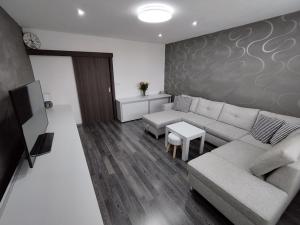 a living room with a couch and a table at Prievidza Home in Prievidza