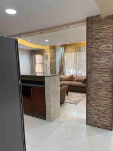 a living room with a kitchen and a couch at 3 bedrooms flat,fully equipped in Cairo