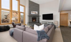 a living room with a couch and a fireplace at Black Eagle 24 in Big Sky