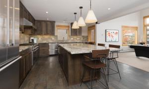 a large kitchen with a large island with bar stools at Black Eagle 24 in Big Sky