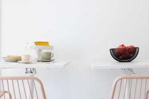 a table with two chairs and a plate of food on it at Essentia Rooms & Relax in Vasto