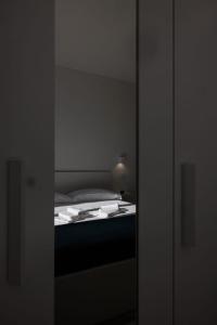 a bedroom with a bed in a room with a mirror at Essentia Rooms & Relax in Vasto