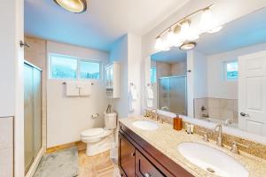 a bathroom with two sinks and a toilet at Bear Valley Mountain Retreat in Anchorage