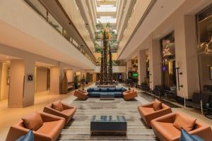 a lobby with a palm tree in the middle at Radisson Blu Hotel, Cairo Heliopolis in Cairo