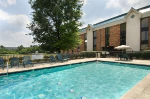 a swimming pool in front of a building at Pear Tree Inn St. Louis Fenton in Fenton