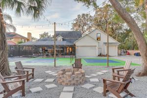 a backyard with two chairs and a fire pit at Exciting Valrico Villa with Private Pool and Game Room in Valrico