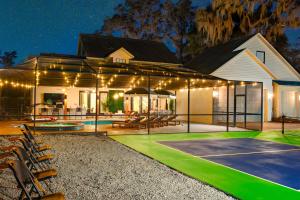 a house with a basketball court and a basketball hoop at Exciting Valrico Villa with Private Pool and Game Room in Valrico