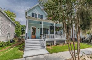 a blue house with a front porch and stairs at Newly Listed Duke St Cottage - Downtown Beaufort in Beaufort