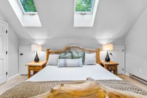 a bedroom with a large bed with two lamps at Private Hideaway with Hot Tub - Stylish & Serene in Ellicottville