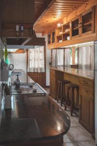a kitchen with a stove and a counter top at CABAÑA EL REMANSO in Villa Pehuenia